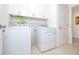 Practical laundry room equipped with a washer and dryer, storage cabinets, and tiled floors at 3810 Arboreal Ct, Deland, FL 32724