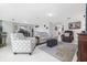 Bright living area with tile flooring, stylish seating, and an open layout leading to the dining area at 3810 Arboreal Ct, Deland, FL 32724