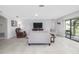 Open living room features tile floors, comfortable seating, and sliding glass doors to patio at 3810 Arboreal Ct, Deland, FL 32724