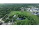 Extensive aerial shot of varied terrain with a house, ponds, and natural forestation at 396 Uranus Trl, Osteen, FL 32764