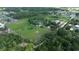 Expansive aerial view of acreage featuring verdant fields and scattered trees with ponds and residential areas at 396 Uranus Trl, Osteen, FL 32764