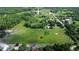 Expansive aerial view of a property featuring large fields, scattered trees, and a tranquil pond at 396 Uranus Trl, Osteen, FL 32764