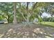Large backyard with shade trees offering a view of the home and a relaxing environment at 396 Uranus Trl, Osteen, FL 32764