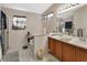 Bright bathroom with double sinks, a framed mirror, and a shower-tub combo at 396 Uranus Trl, Osteen, FL 32764