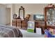 Bedroom featuring a dresser with mirror, adjacent to a display cabinet at 396 Uranus Trl, Osteen, FL 32764