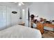 Bright bedroom featuring natural light, ceiling fan, closet and a work space at 396 Uranus Trl, Osteen, FL 32764