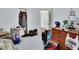 Neutral bedroom featuring a mix of personal items and an open closet for accessibility at 396 Uranus Trl, Osteen, FL 32764