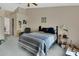 Bedroom features an unmade bed, ceiling fan, and a view to the next room at 396 Uranus Trl, Osteen, FL 32764