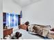 Bedroom featuring a bed, side table and a sunny window at 396 Uranus Trl, Osteen, FL 32764