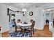 Cozy dining area with a chandelier, table set for four, and sliding door to the patio at 396 Uranus Trl, Osteen, FL 32764