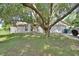 Charming single-story home with a well-maintained lawn and mature tree in the front yard at 396 Uranus Trl, Osteen, FL 32764