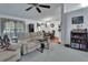 Bright living room area showing a large window and tan sofa with a glimpse into the dining area at 396 Uranus Trl, Osteen, FL 32764