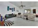 Spacious living room features ceiling fan, multiple seating options and an open layout with natural light at 396 Uranus Trl, Osteen, FL 32764