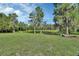 Scenic view of a peaceful pond surrounded by lush greenery and trees with Spanish moss at 396 Uranus Trl, Osteen, FL 32764