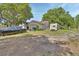 Property featuring a single-Gathering home, vehicles, large trees, and yard space at 396 Uranus Trl, Osteen, FL 32764