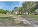 Property showcasing a quaint single-Gathering home with a large yard and mature trees at 396 Uranus Trl, Osteen, FL 32764