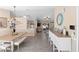 Open-concept dining room featuring stylish lighting fixture, wood-look flooring, and a decorative console table at 413 Coventry Estates Blvd, Deltona, FL 32725