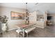 Cozy dining area with a rustic table, decorative chandelier, and views into the adjacent kitchen and living areas at 413 Coventry Estates Blvd, Deltona, FL 32725