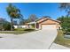 Charming home with an attached two-car garage and well-maintained lawn at 413 Coventry Estates Blvd, Deltona, FL 32725