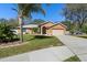 A charming single-story home has a well-manicured lawn and an arched entryway at 413 Coventry Estates Blvd, Deltona, FL 32725