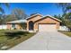 Charming single-story home showcasing a well-maintained lawn, two-car garage, and inviting front entrance at 413 Coventry Estates Blvd, Deltona, FL 32725