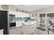 Bright kitchen features white cabinets, granite counters, and a stylish backsplash with stainless steel appliances at 413 Coventry Estates Blvd, Deltona, FL 32725
