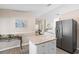 Open concept kitchen with granite counters, stainless refrigerator and a spacious center island for easy food preparation at 413 Coventry Estates Blvd, Deltona, FL 32725