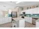 Spacious kitchen with white cabinets, stainless appliances, granite counters, and a center island with bar seating at 413 Coventry Estates Blvd, Deltona, FL 32725