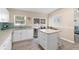 Bright kitchen with granite counters, island, and sliding door to a screened patio for indoor/outdoor living at 413 Coventry Estates Blvd, Deltona, FL 32725
