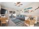 Comfortable living room featuring a cozy sofa, stylish decor, and a sliding glass door leading to outdoor space at 413 Coventry Estates Blvd, Deltona, FL 32725