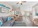 Open-concept living room featuring comfortable seating, stylish decor, and connecting views to the dining area and kitchen at 413 Coventry Estates Blvd, Deltona, FL 32725