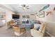 Bright living room featuring comfortable seating, decorative accents, and an adjacent dining area at 413 Coventry Estates Blvd, Deltona, FL 32725