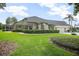 Manicured backyard featuring a screen enclosure, striped awnings, and lush landscaping at 420 Greenridge Ct, Debary, FL 32713