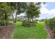 Lush backyard with mature trees and landscaping, offering a peaceful outdoor space at 420 Greenridge Ct, Debary, FL 32713