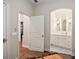 Bright hallway view to a bathroom with white cabinets, modern fixtures, and custom lighting at 420 Greenridge Ct, Debary, FL 32713