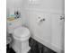 Convenient half bathroom with black tile flooring, white fixtures, and board and batten wall accents at 420 Greenridge Ct, Debary, FL 32713