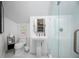 Bright bathroom with pedestal sink, glass-enclosed shower, and tiled floors at 420 Greenridge Ct, Debary, FL 32713