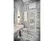Elegant bathroom with full marble features, a glass walk-in shower, and natural light at 420 Greenridge Ct, Debary, FL 32713