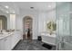 Elegant primary bathroom with a soaking tub, large shower, dual sink vanity, and natural light at 420 Greenridge Ct, Debary, FL 32713