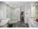 Spa-like bathroom featuring a walk-in shower and soaking tub, with dual vanities and custom closet at 420 Greenridge Ct, Debary, FL 32713