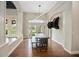 Bright dining room with modern light fixture, decorative buffalo head, and rich wood flooring at 420 Greenridge Ct, Debary, FL 32713