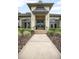 Close-up of the front entrance featuring a pathway leading to double doors with elegant lighting fixtures at 420 Greenridge Ct, Debary, FL 32713