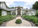 Stately home with manicured landscaping, circular walkway, and elegant double-door entrance at 420 Greenridge Ct, Debary, FL 32713