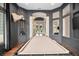 Spacious game room featuring a pool table, custom decor, and an archway leading to the front entrance at 420 Greenridge Ct, Debary, FL 32713