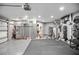 Spacious garage with epoxy flooring, storage cabinets, and workout equipment at 420 Greenridge Ct, Debary, FL 32713