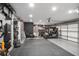 Spacious garage featuring a home gym area, storage, epoxy flooring and a golf cart at 420 Greenridge Ct, Debary, FL 32713