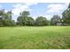 Beautiful golf course with vibrant green grass and mature trees in the background at 420 Greenridge Ct, Debary, FL 32713