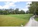 Scenic view of a well-maintained golf course with trees and a sand trap at 420 Greenridge Ct, Debary, FL 32713