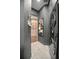Hallway featuring modern washer and dryer unit with marble floors and stylish cabinets at 420 Greenridge Ct, Debary, FL 32713