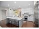 Bright kitchen featuring a large island, modern appliances, and stylish white cabinetry at 420 Greenridge Ct, Debary, FL 32713